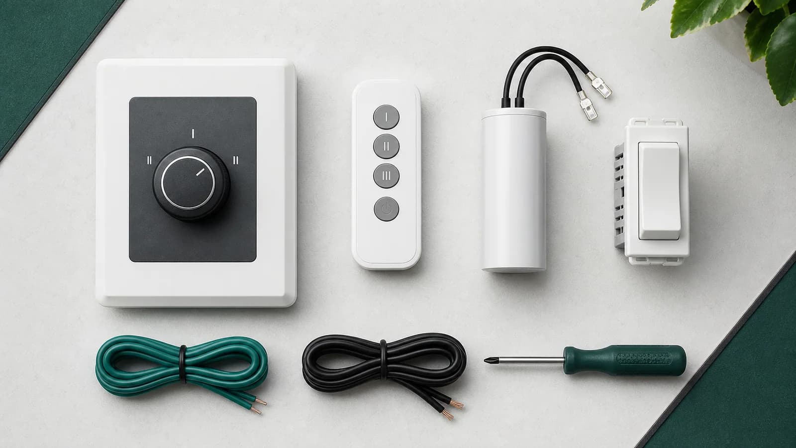 Controle de parede, controle remoto, receptor e capacitores de ventilador organizados sobre bancada técnica
